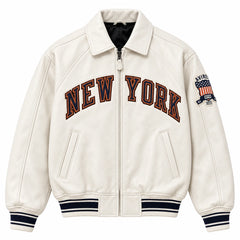 Front view of cream Avirex Kith Knicks varsity bomber jacket with NEW YORK chest lettering and striped rib-knit trims