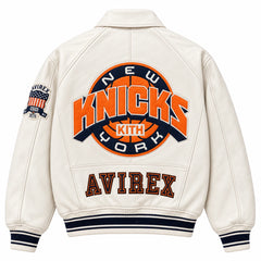 Full back view of cream Kith Knicks varsity jacket with large basketball logo, KITH detail and AVIREX lettering