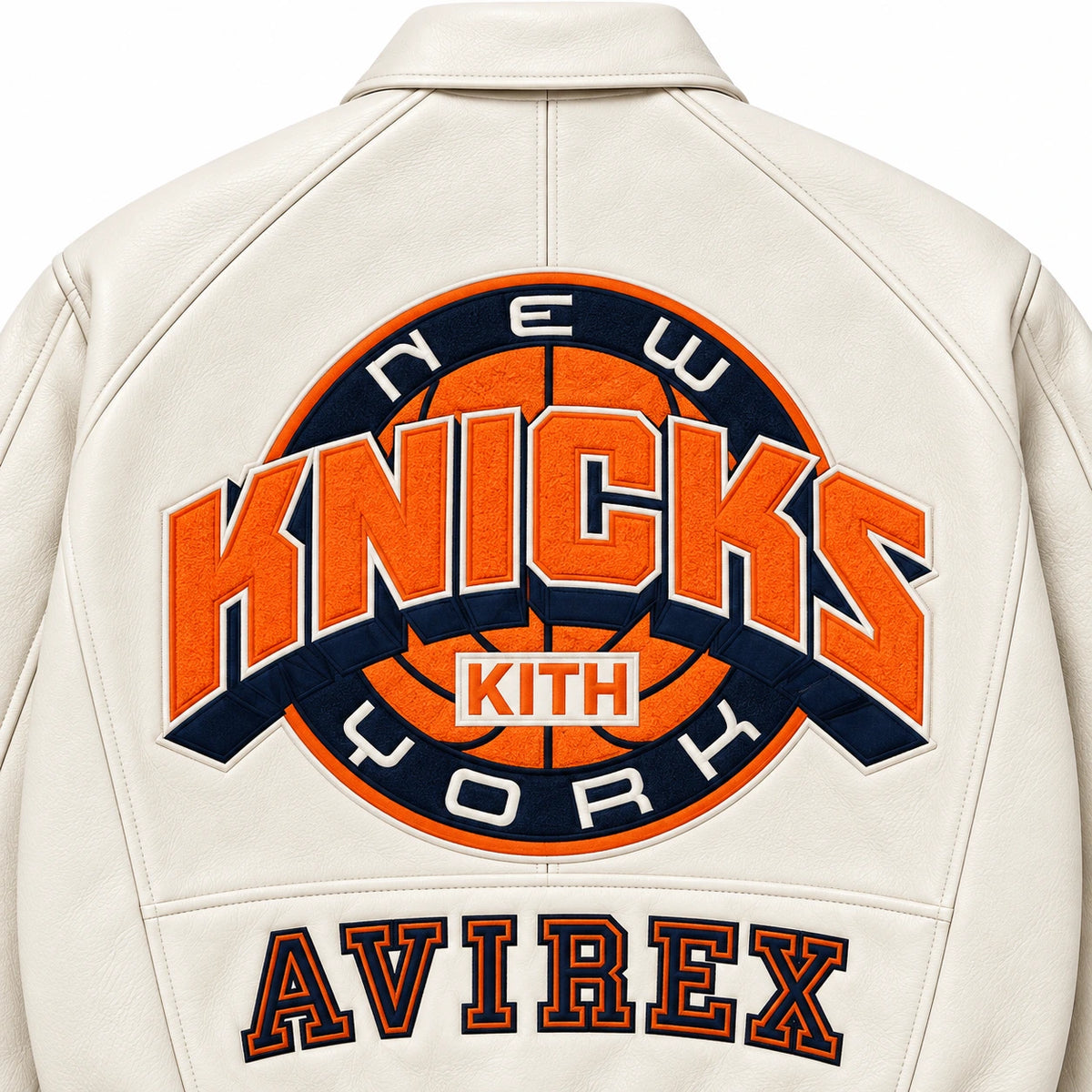 Close-up back of cream Avirex Kith Knicks jacket showing orange navy basketball graphic and AVIREX lettering
