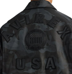 Close-up rear view of Avirex camo leather jacket showing tonal AVIREX lettering, monochrome crest and USA appliqué