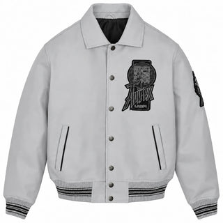 Front view of Avirex grey leather varsity jacket with snap-button closure, chest graphic, vertical pockets and striped trims