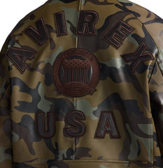 Close-up back detail of Avirex olive camo leather bomber showing AVIREX lettering, heritage crest and USA appliqué
