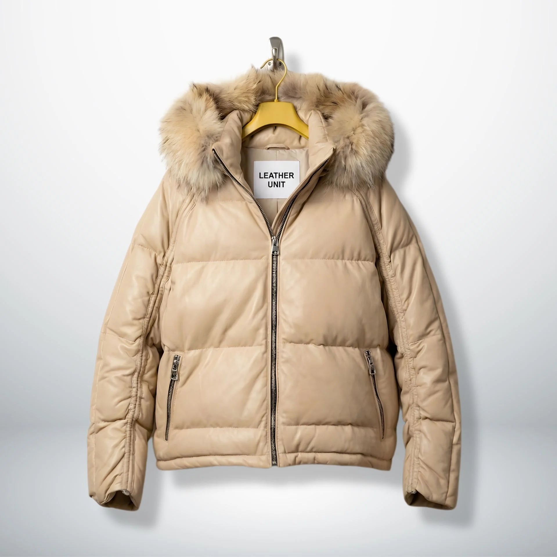 Front view of beige leather puffer jacket with real fur hood and zip pockets.