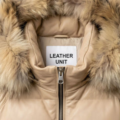 Close‑up of fur‑trim hood and collar on beige leather puffer jacket.