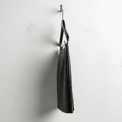 Opposite side view of black croc embossed mini leather skirt