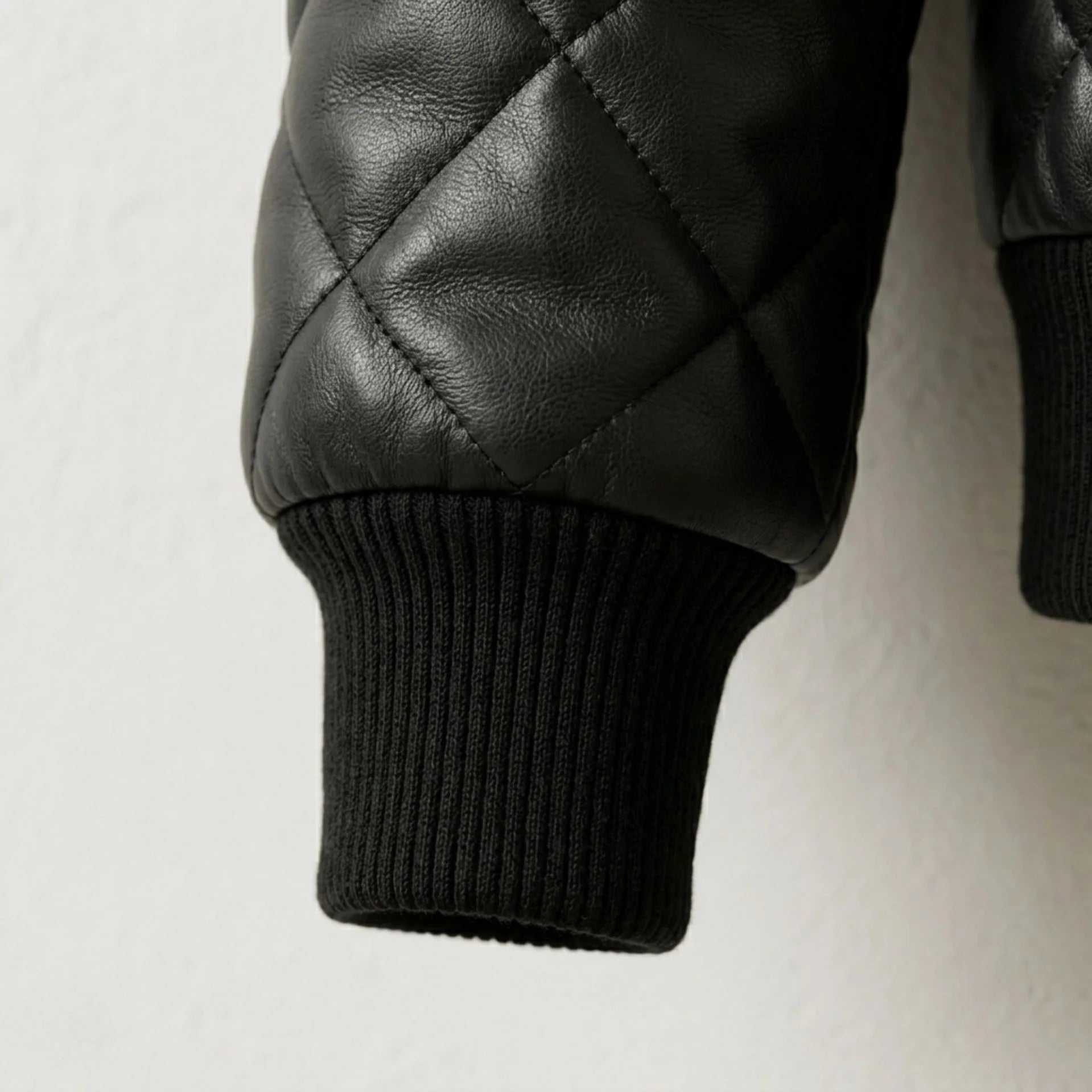Detailed view of ribbed cuff and premium quilted leather texture
