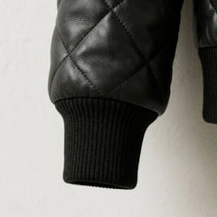 Detailed view of ribbed cuff and premium quilted leather texture