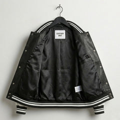 Interior lining of black and white varsity leather jacket showing inner pocket