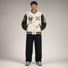 Front studio view of Bone Club skull varsity jacket showing bone-white body, black sleeves and embroidered Halloween patches