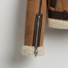 Front zipper, welt pockets and belted hem on brown sherpa leather jacket