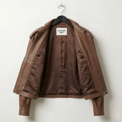 Interior lining of womens brown leather bomber jacket showing inner pockets