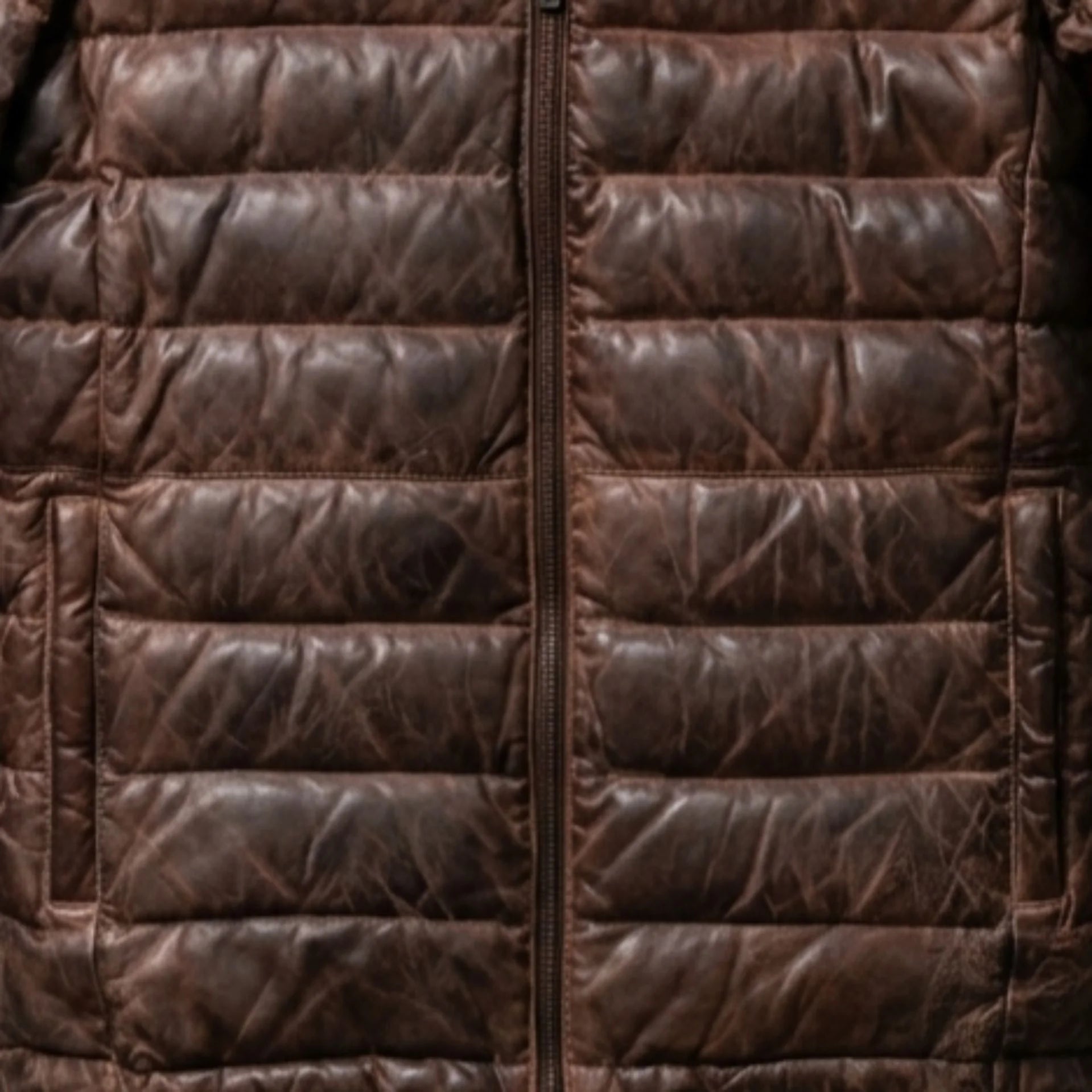 Close-up of functional pockets and heavy-duty zipper on brown leather down puffer jacket