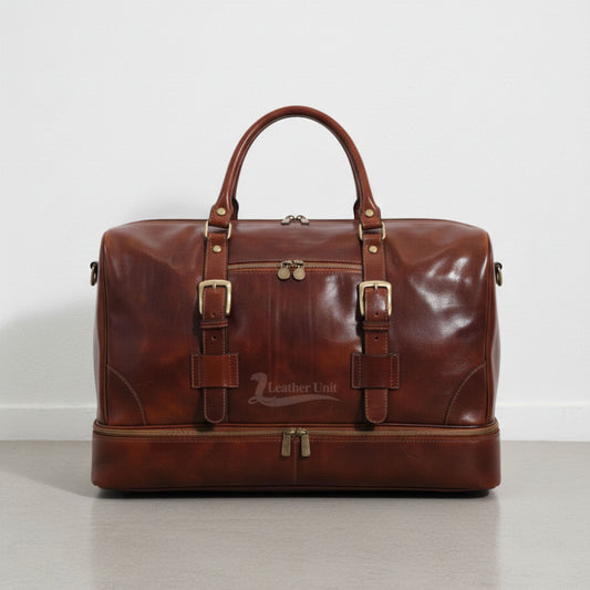 front view brown leather drop bottom duffle bag with buckles and front zip pocket by Leather Unit.