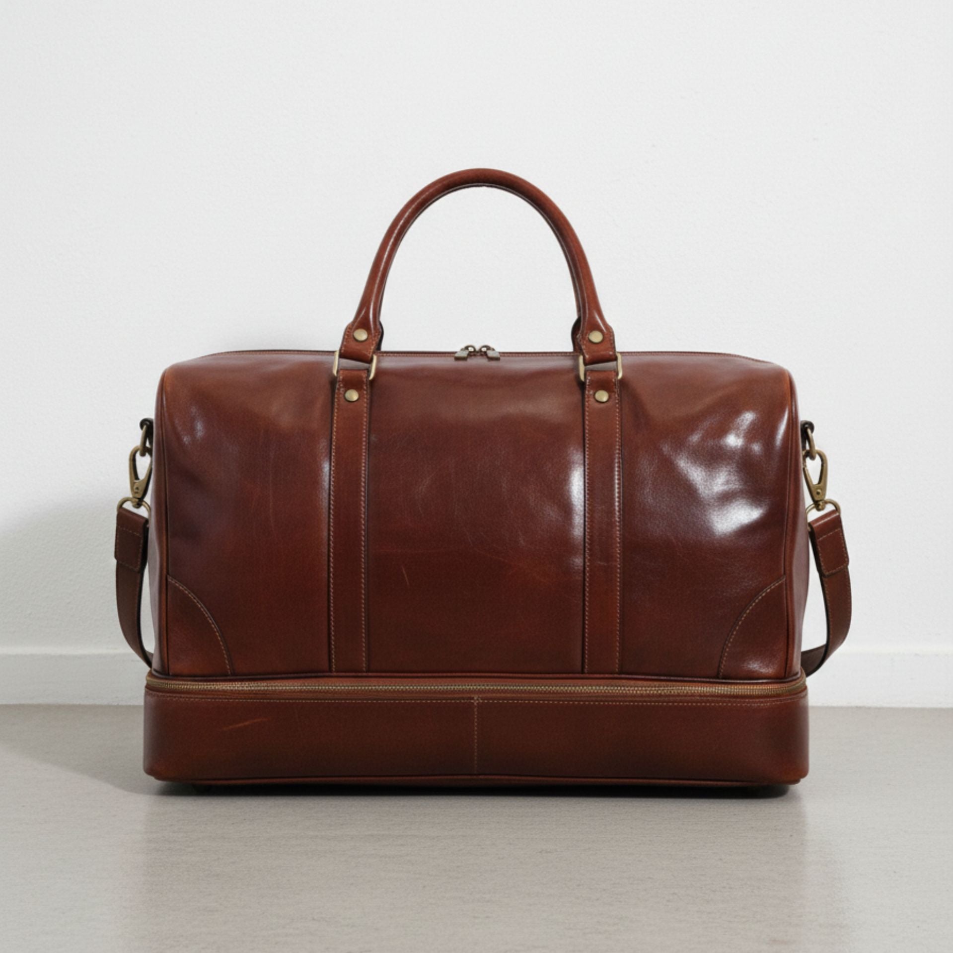 back view brown genuine leather travel duffle bag with detachable shoulder strap.