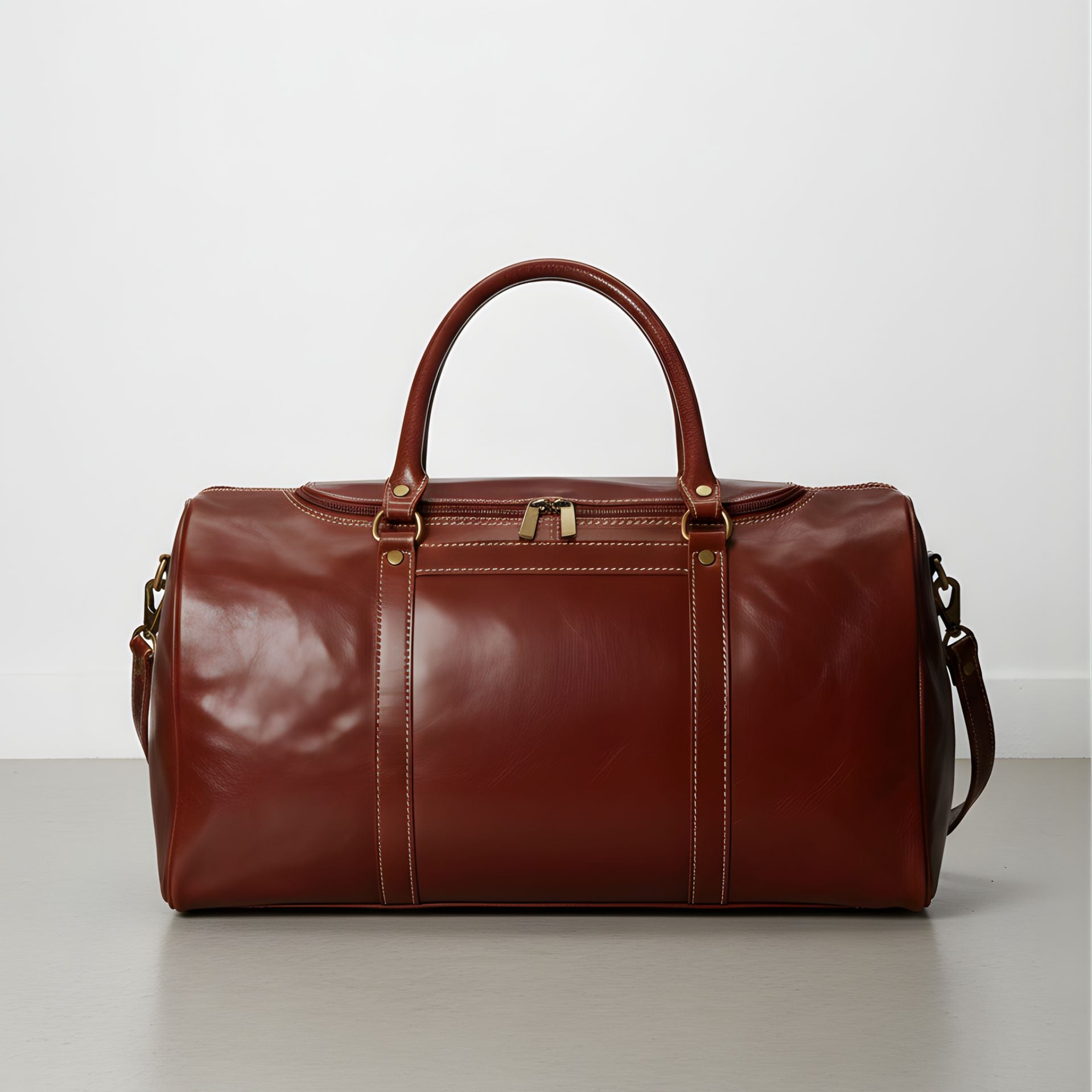 brown leather duffle bag with detachable shoulder strap and double handles.