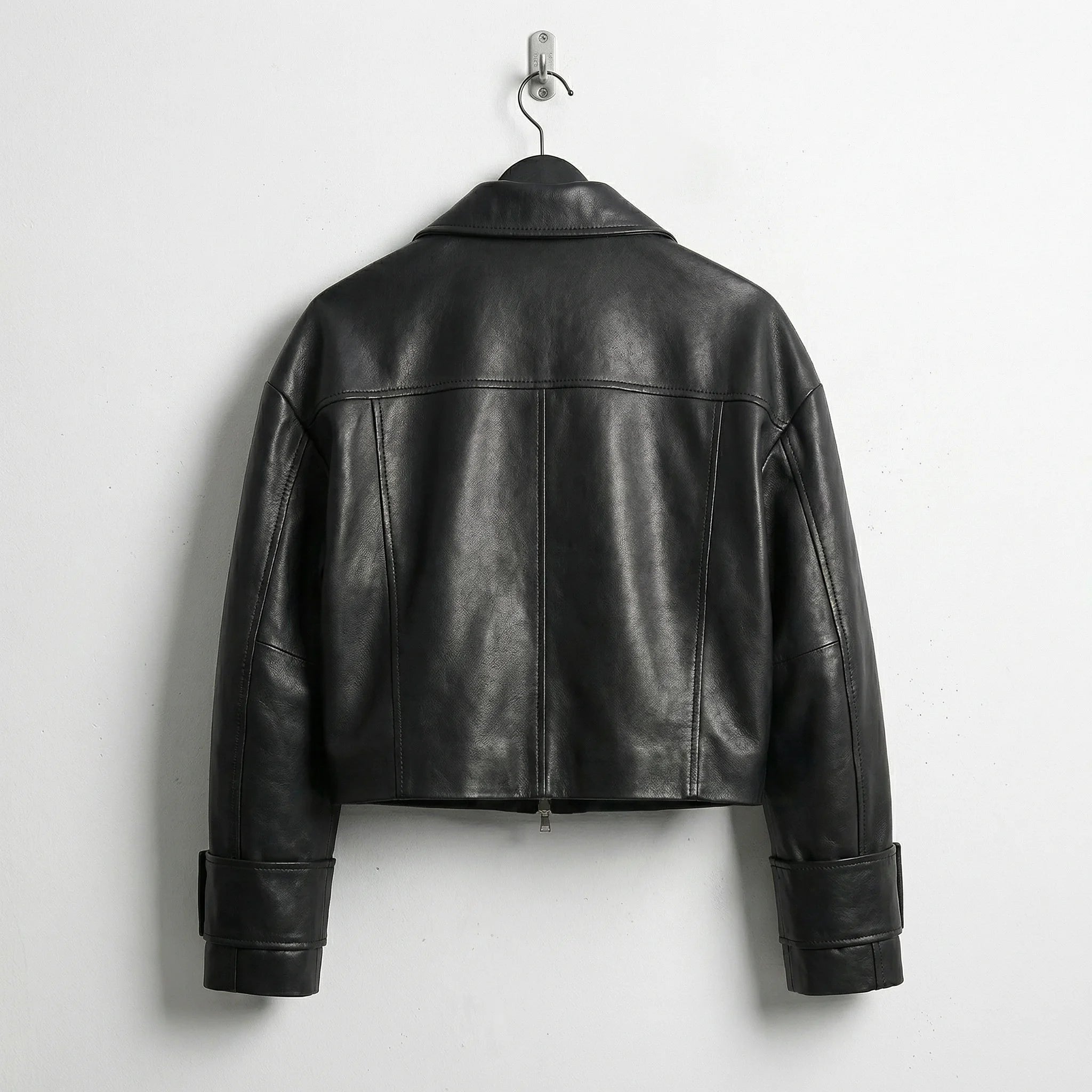 Back view of cropped black leather jacket for women