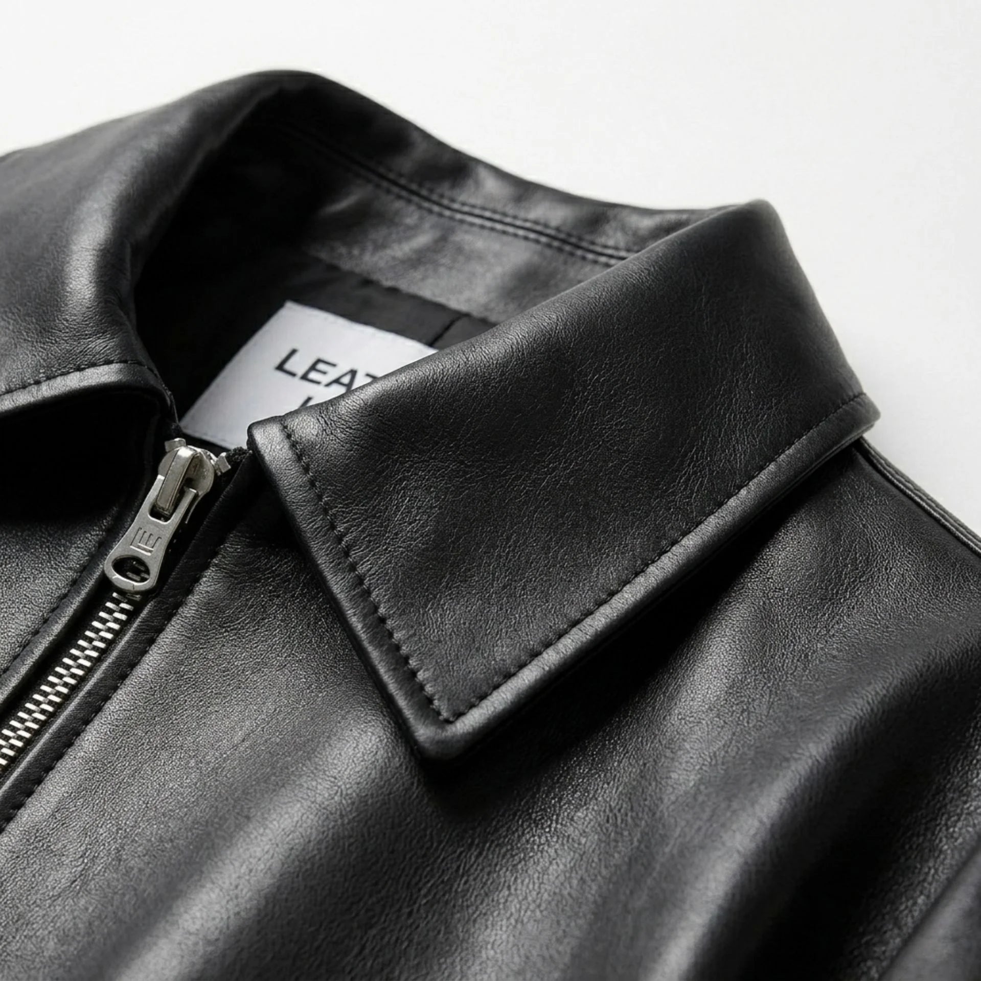 Pointed collar and front zipper detail on womens black leather jacket