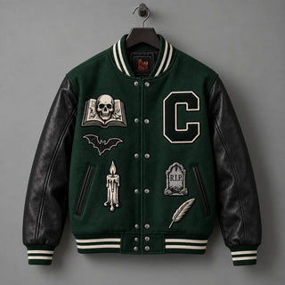 Front hanger view of forest green varsity jacket with genuine black leather sleeves and gothic embroidery
