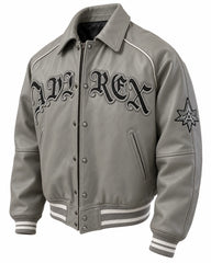 Angled grey leather varsity jacket with black chest lettering, zip and snap front, sleeve emblem and striped ribbed trims