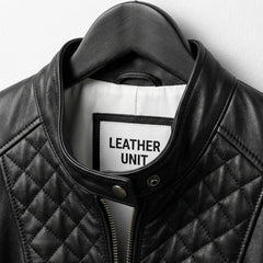 Close-up of snap collar and label on Leather Unit black quilted jacket