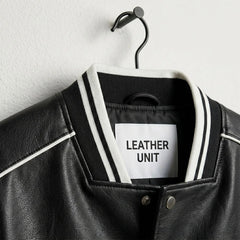 Striped rib knit collar detail on Leather Unit black and white varsity jacket