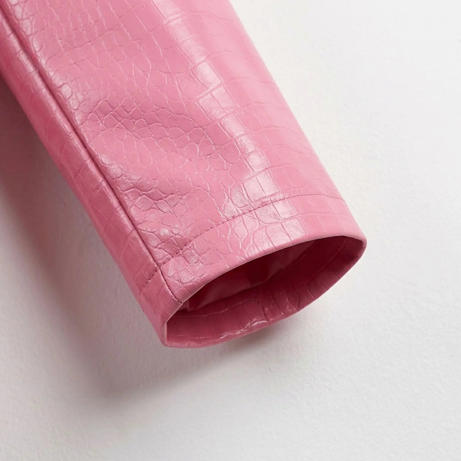 Sleeve cuff detail on croc-embossed blush pink leather blazer