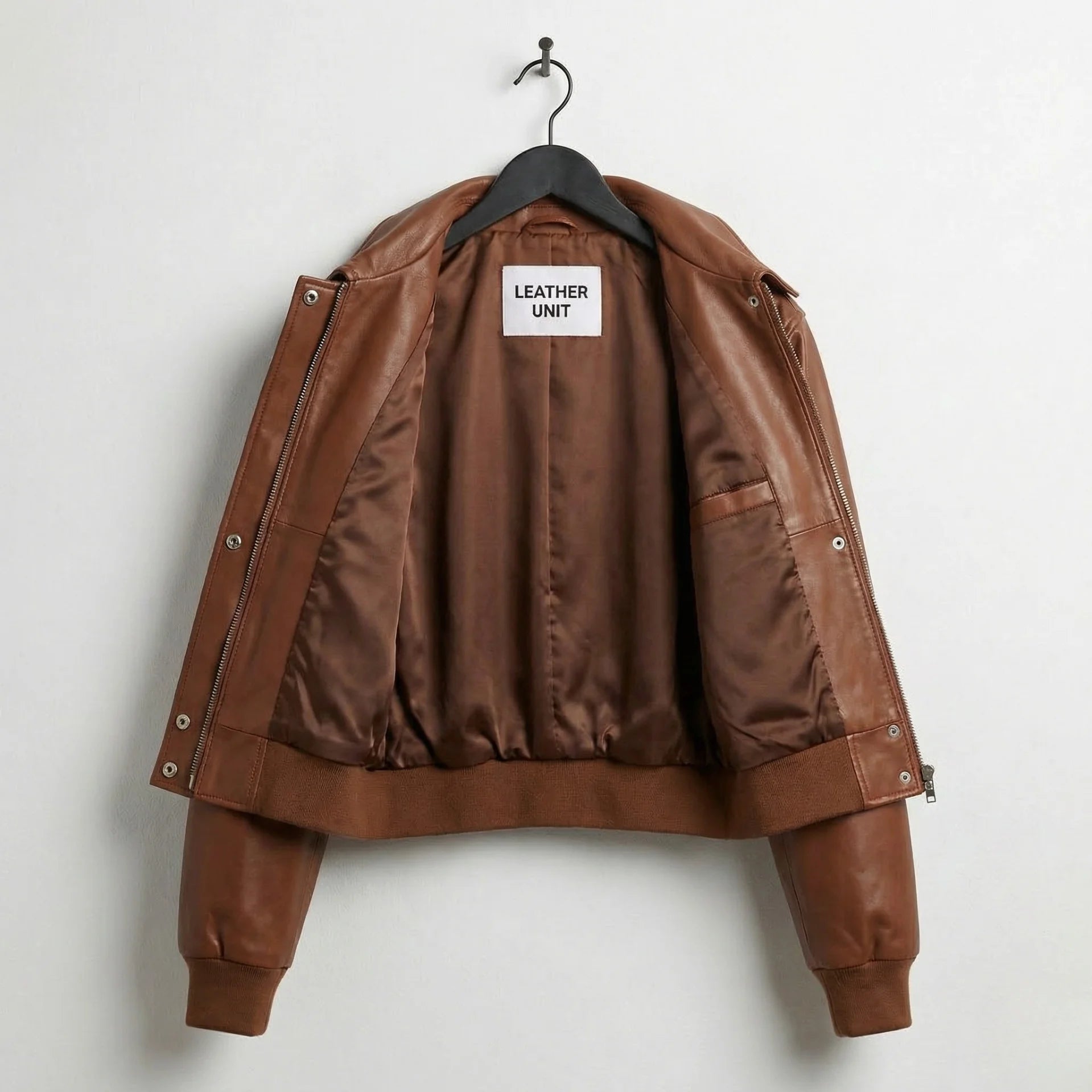 Inside lining of women’s brown cropped leather bomber jacket with inner pocket