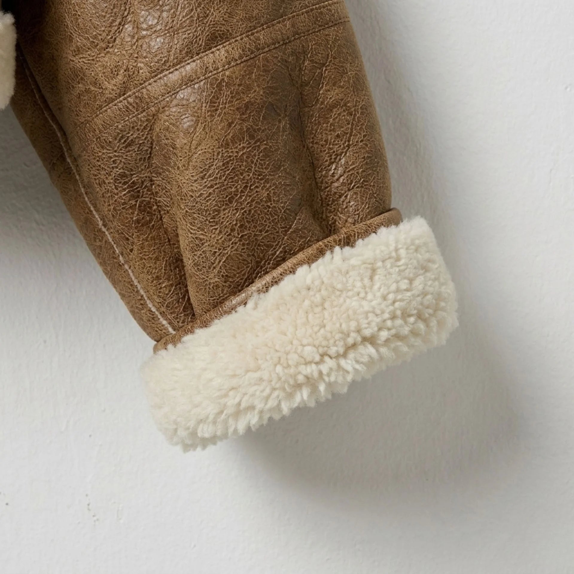 Women’s brown cropped shearling aviator jacket with fur cuffs