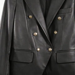 Gold button front and flap pockets on women’s double breasted black leather blazer