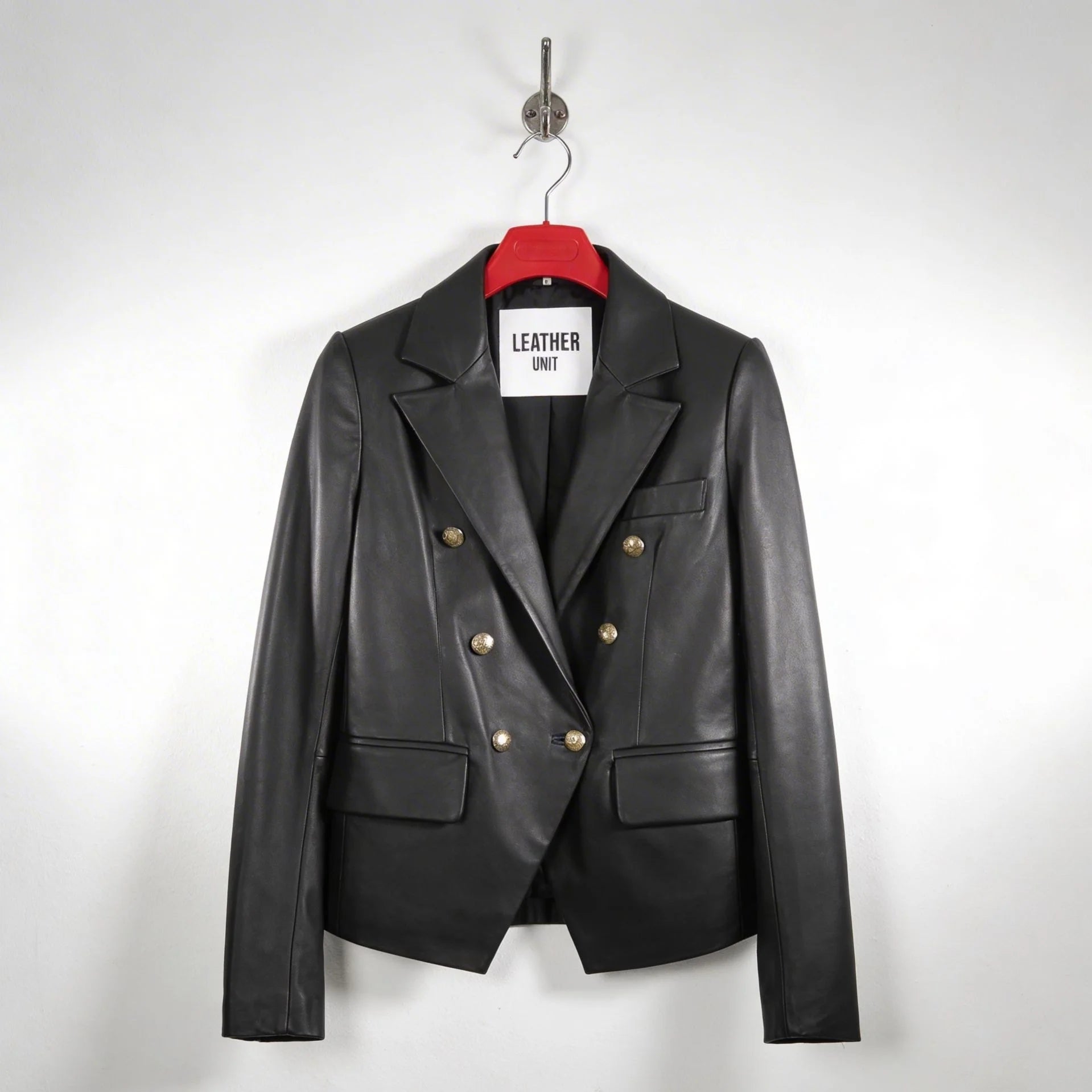 Front view of women’s double breasted black leather blazer with gold buttons by Leather Unit