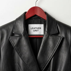 Close up of notched lapels and Leather Unit label on black leather blazer