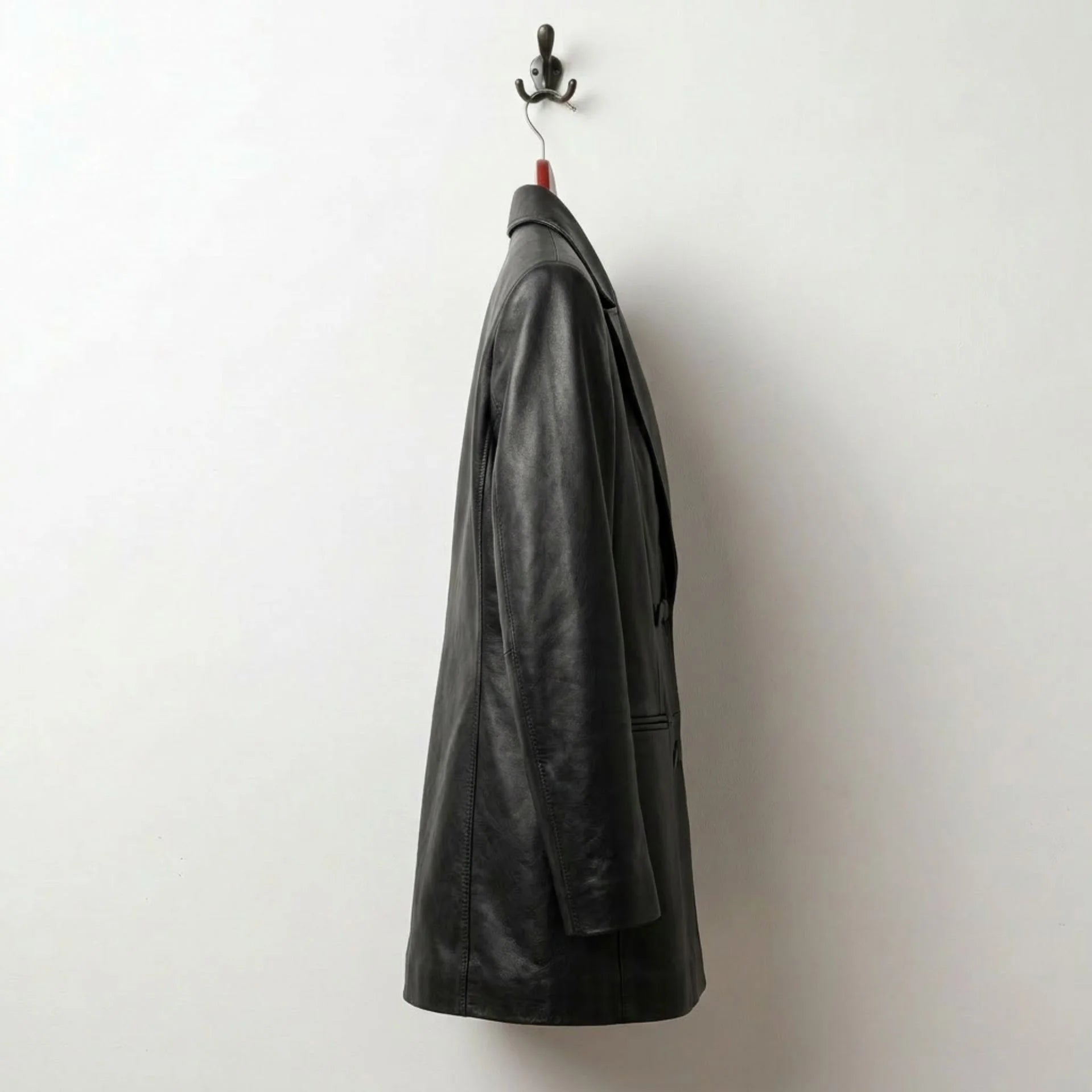 Side profile of tailored long black leather blazer for women