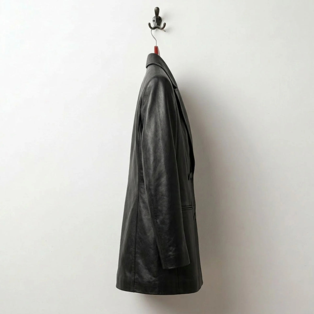 Side profile of tailored long black leather blazer for women