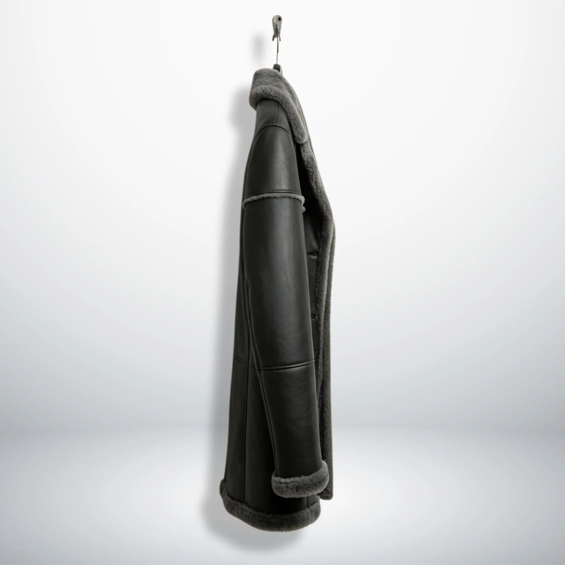 Side profile of men’s long grey shearling leather jacket showing length