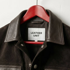 Close-up of smooth leather collar on men's brown suede trucker jacket by Leather Unit