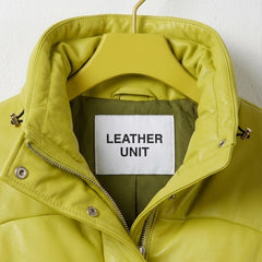 Close-up of padded stand-up collar on neon lime puffer leather jacket by Leather Unit