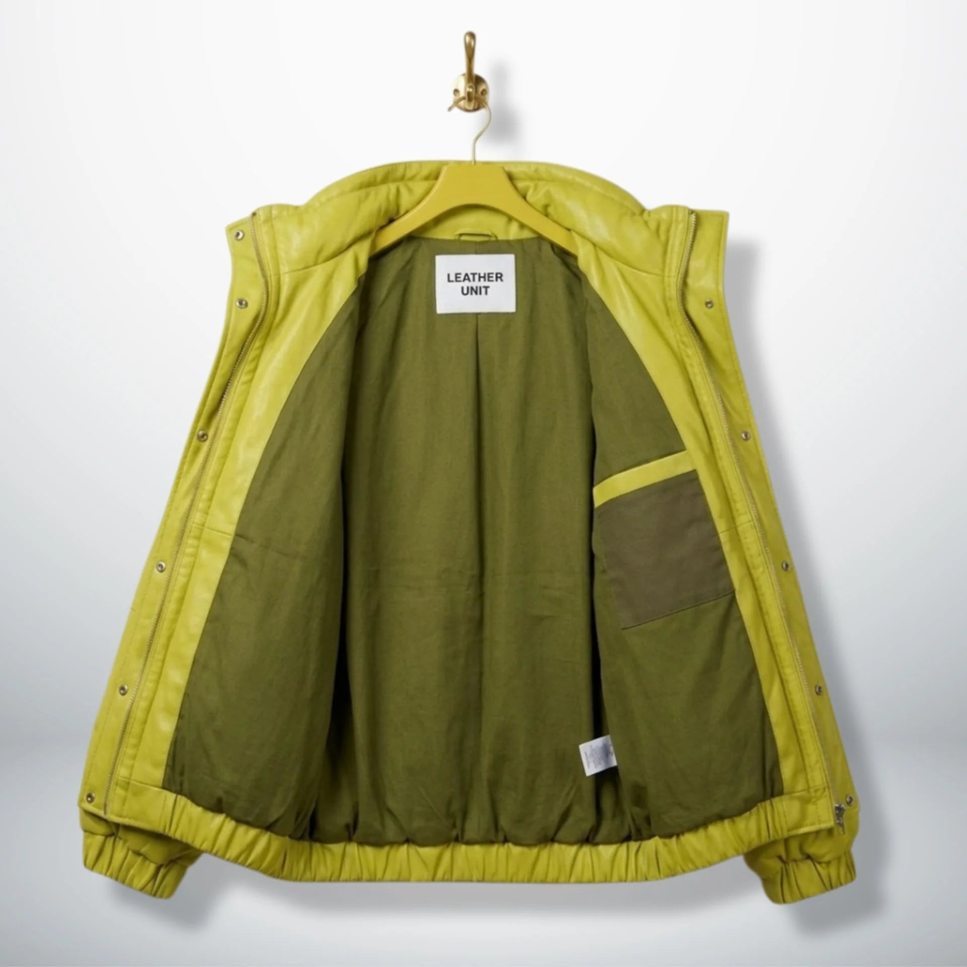 Interior olive lining of unisex neon lime puffer leather jacket showing inner pocket