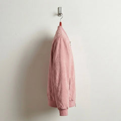 Side profile of pink suede bomber jacket showing slim fit