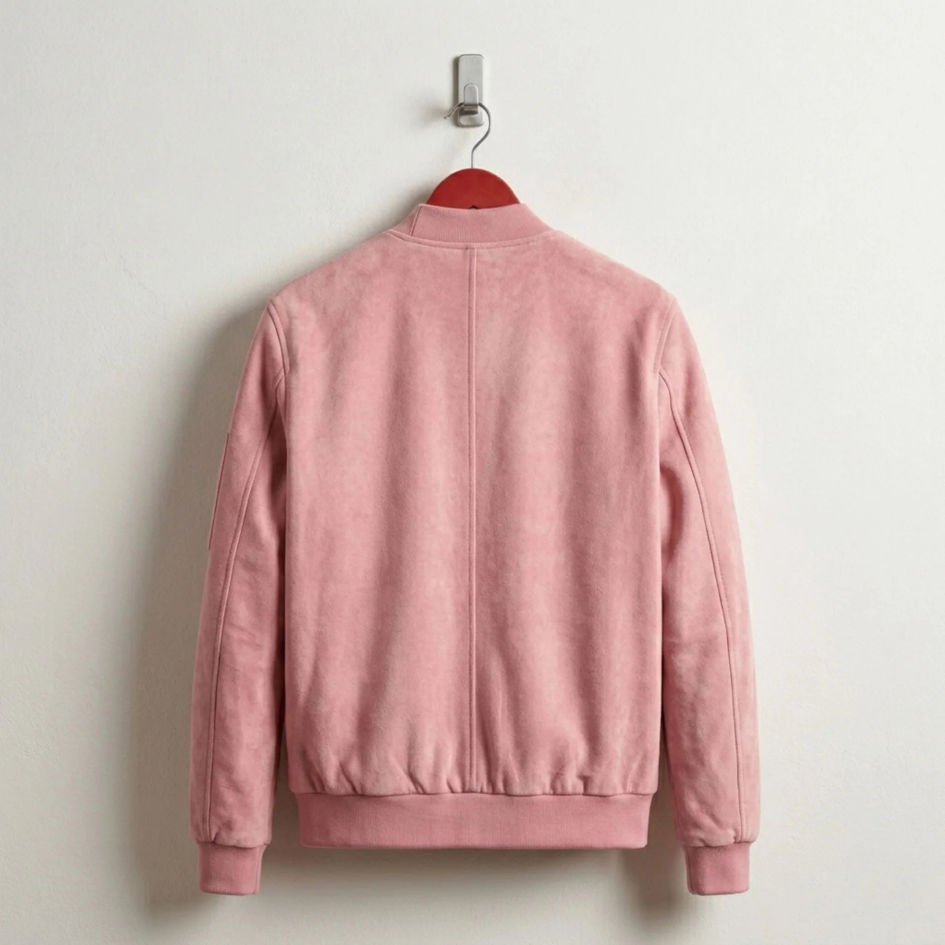 Back view of pastel pink suede bomber jacket with ribbed hem