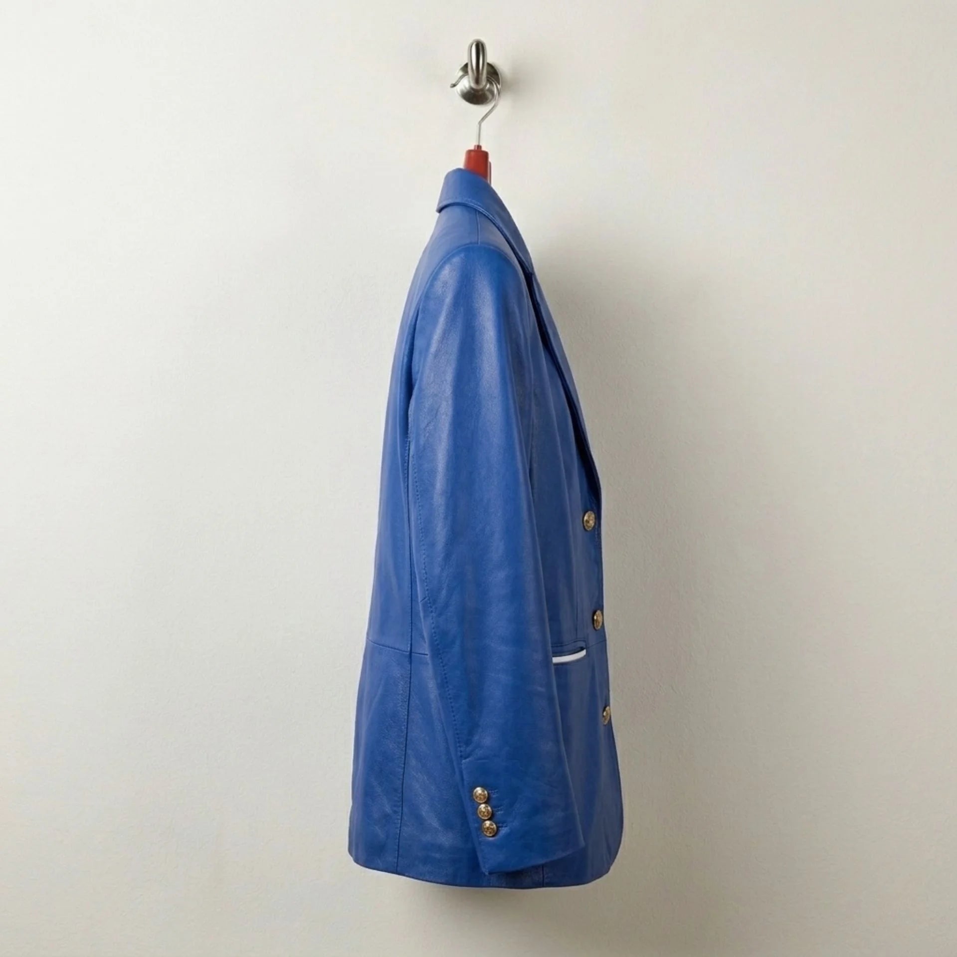Side profile of tailored women’s royal blue leather blazer