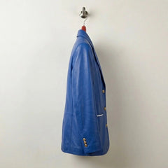 Side profile of tailored women’s royal blue leather blazer