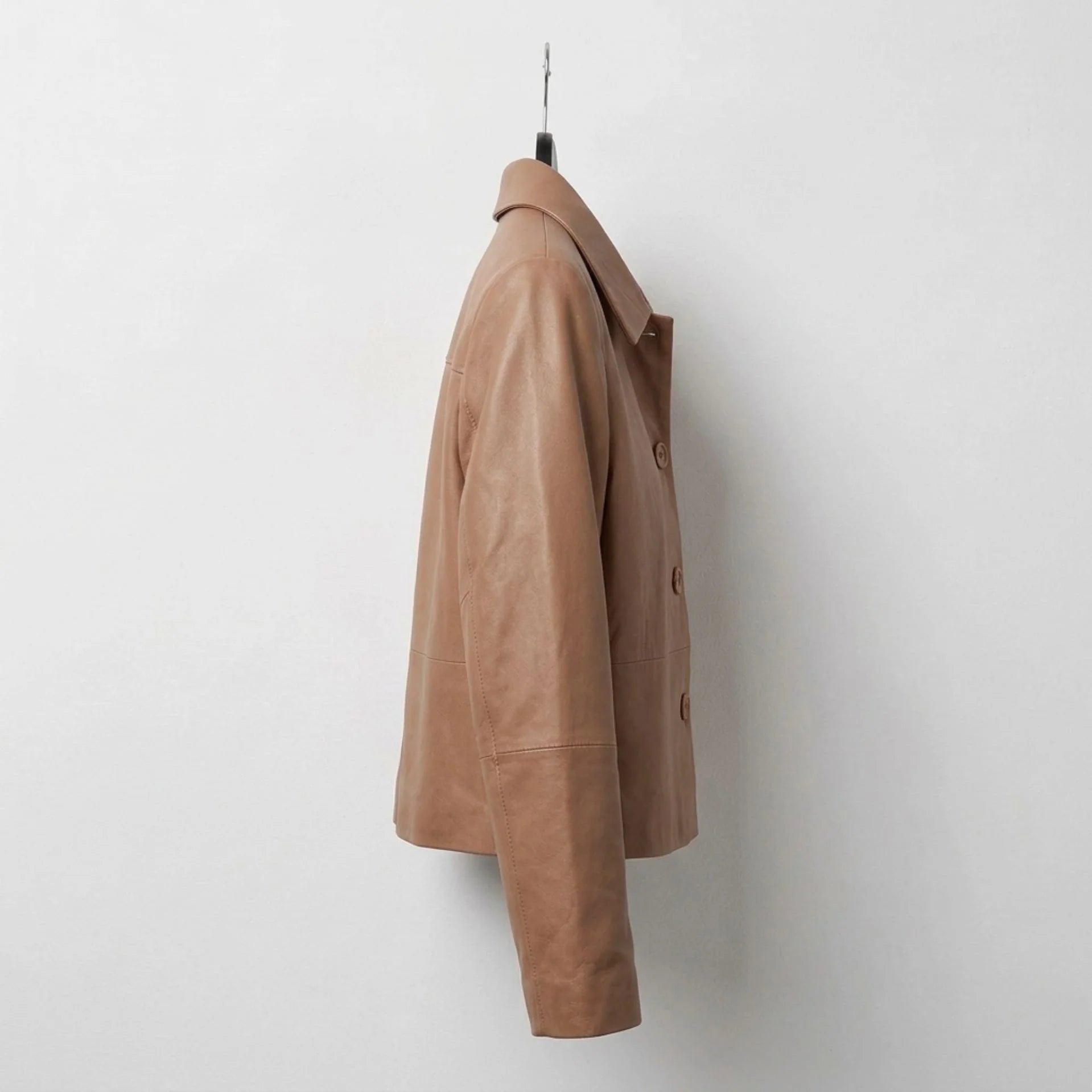 Women's tan cropped leather shirt jacket side profile view