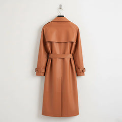 Back view of long belted tan leather trench coat for women