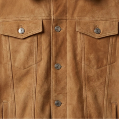 Chest flap pockets and metal button detail on men's tan suede trucker jacket