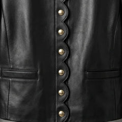 Close up of scallop edge front and gold buttons on women’s black leather blazer