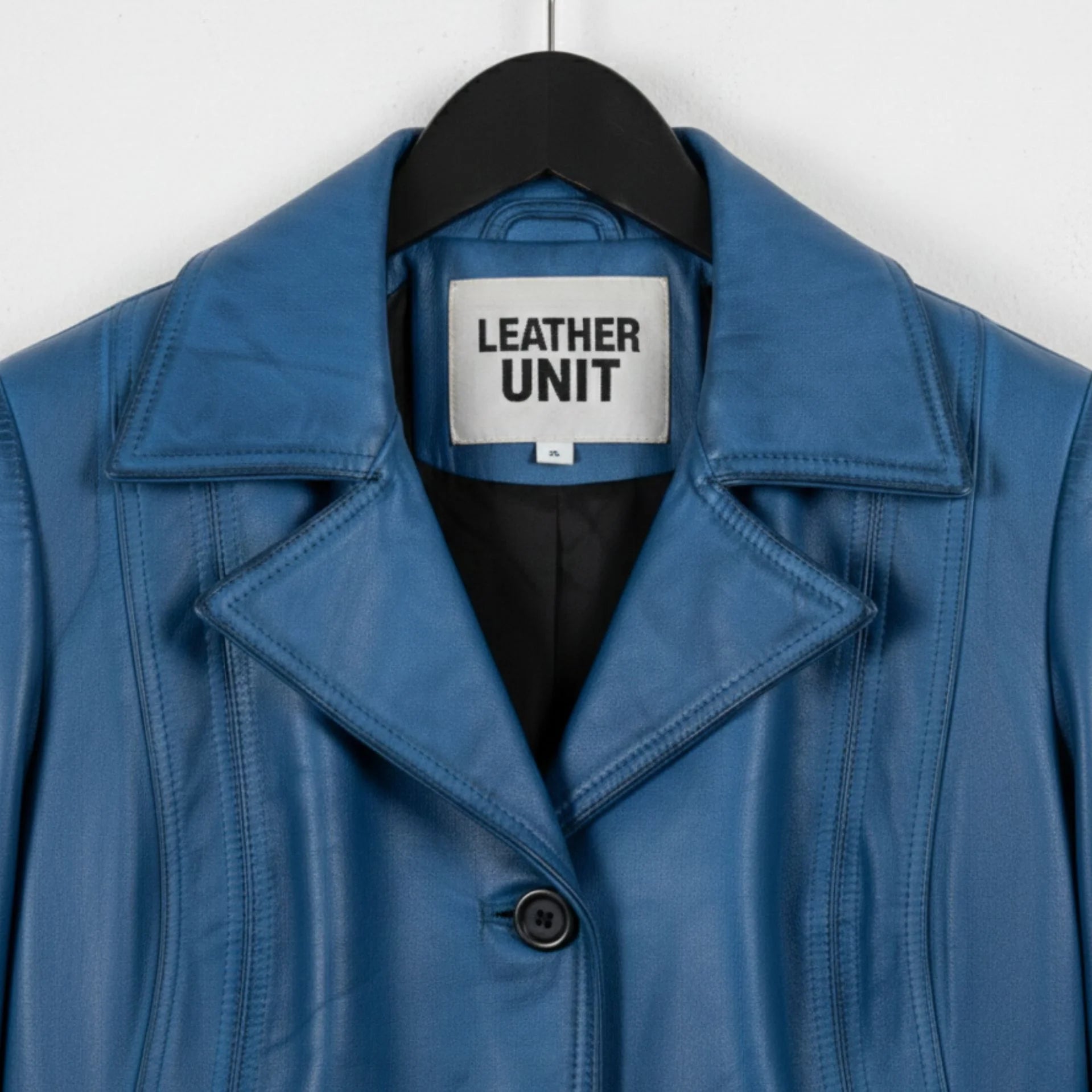 Close up of notch lapel and Leather Unit label on blue waxed leather coat