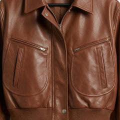Pocket and zipper detail on women’s brown cropped leather bomber jacket