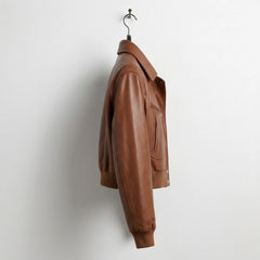 Side profile of women’s brown cropped leather bomber jacket showing shirt collar