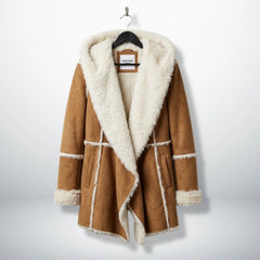 Front view of women’s brown suede shearling hooded coat by Leather Unit