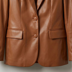 Two button front and flap pockets on women’s cognac brown leather blazer